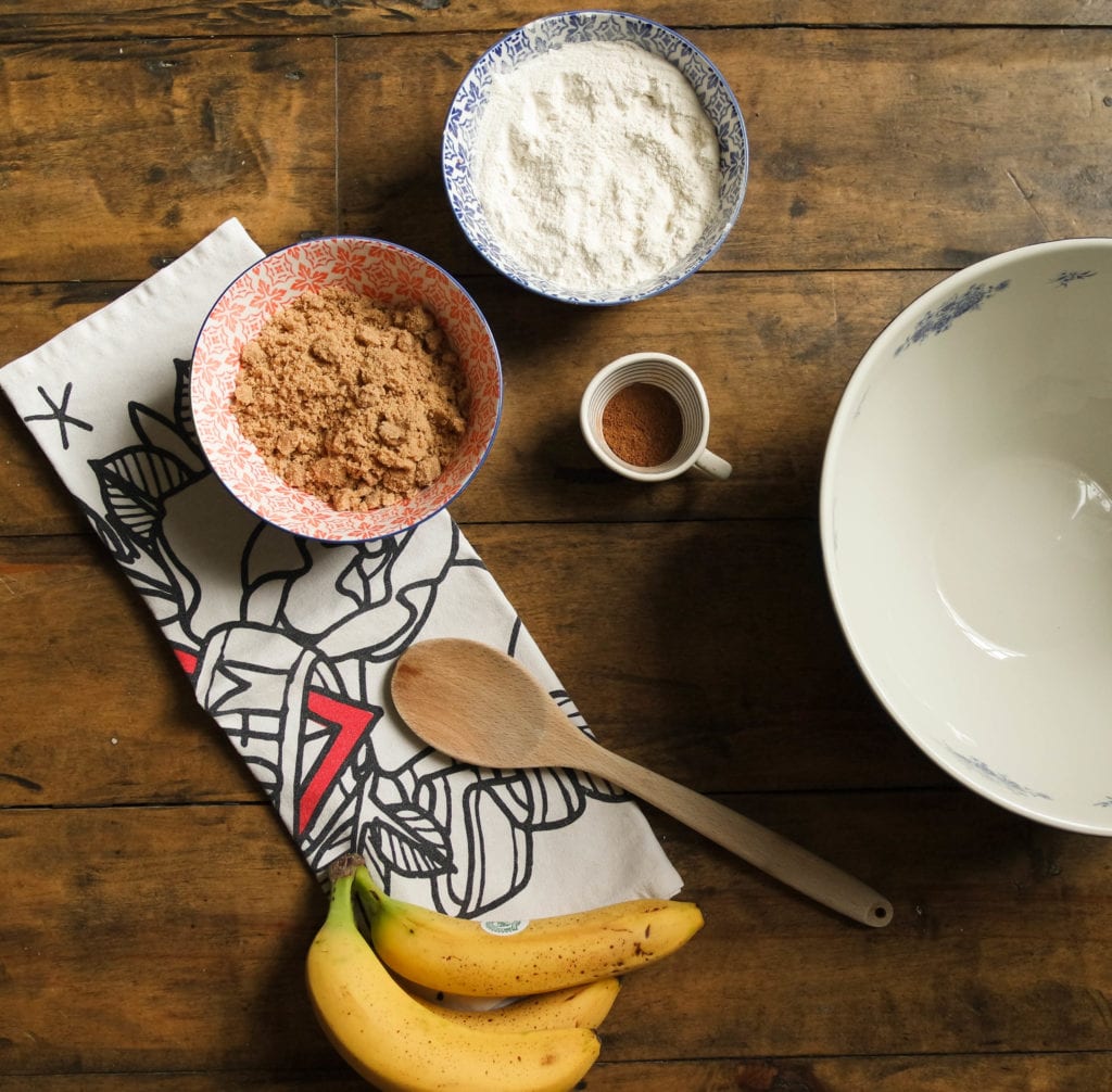 Ingredients for banana bread on a wooden table. Bananas, sugar, flour, oil.