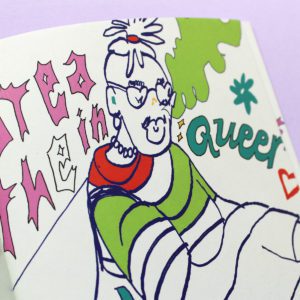 A figure wearing glasses is depicted in loose line drawing in blue, green and pink ink, with their hair worn up. Behind them the words ‘Breathe in Queer’ are drawn in pink letters.