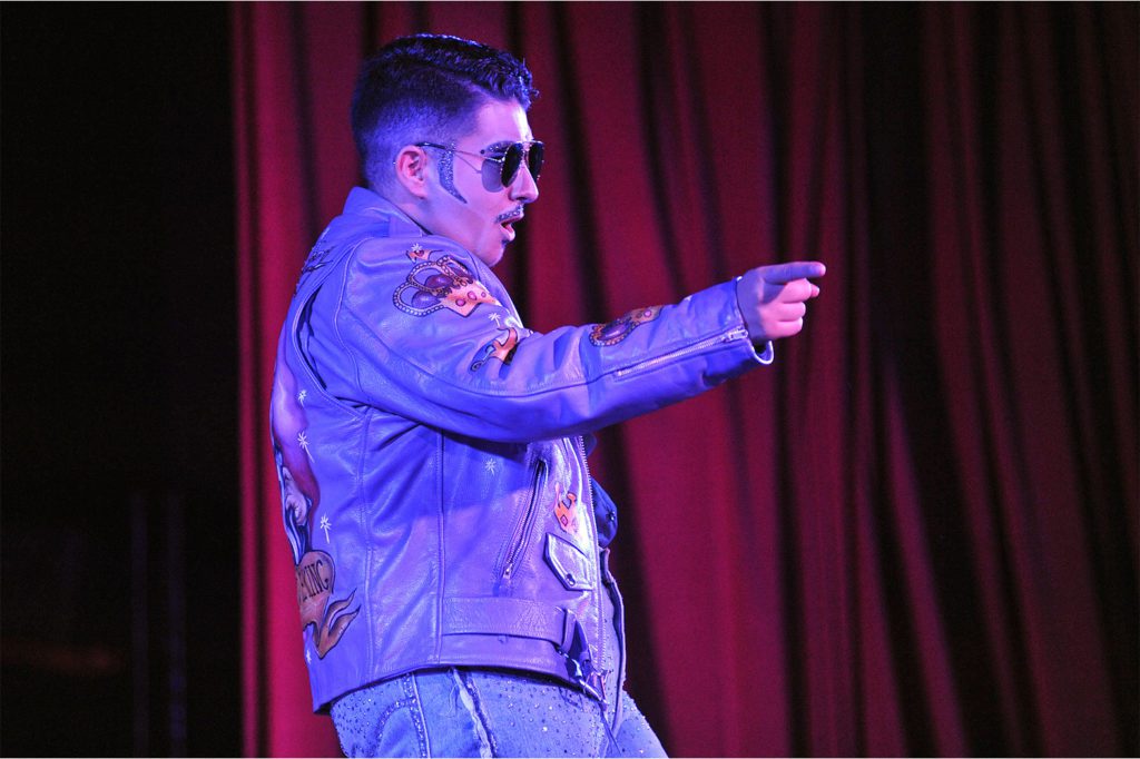 drag king Mark Anthony performs in aviator sunglasses and leather biker jacket