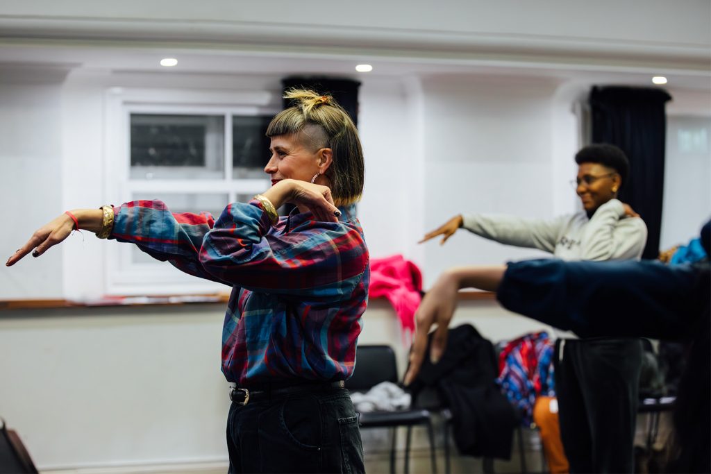 People do arm poses in a dance workshop