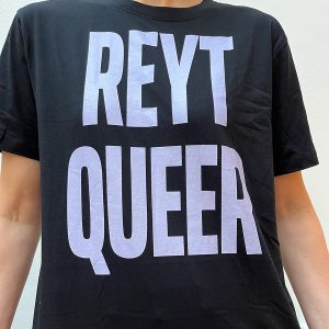 Reyt Queer large bold lavender text on a black T shirt modelled by a white person