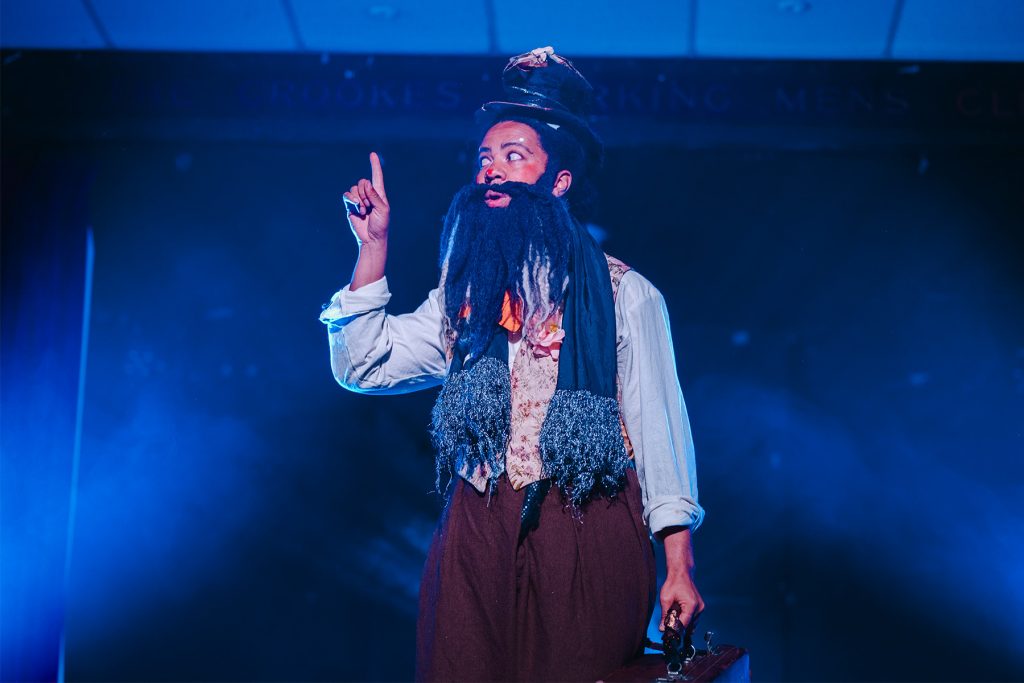Black Drag king Richard Melanin the Third exclaims with his finger in the air
