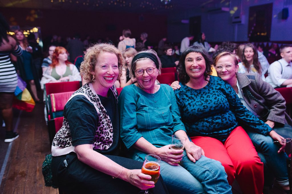 Smiling audience members of all ages