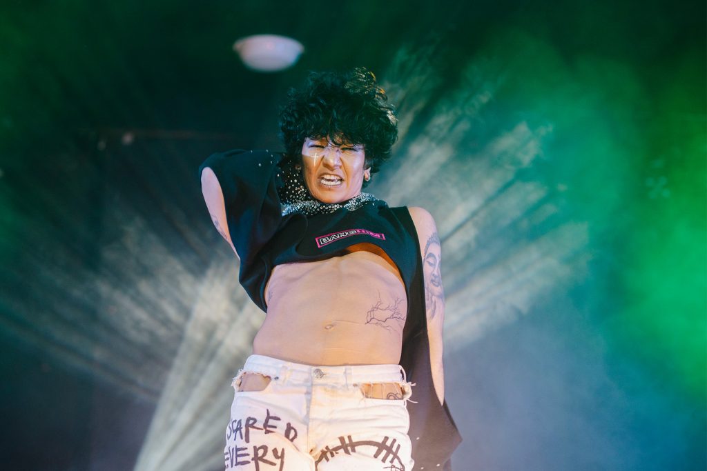 drag king Chiyo, performs on stage showing off his washboard abs