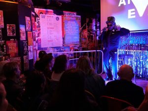 Black drag king Lionel Bitchie sings live onstage